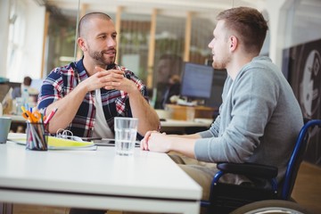 businessman discussing with colleague in office