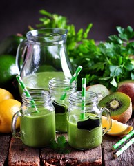 Green smoothies from fresh kiwi, avocado, apple, lemon, baby spinach and parsley. Healthy eating.
