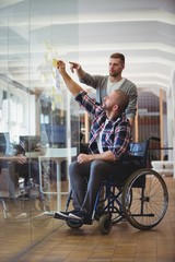 Handicap businessman  sticking adhesive notes 