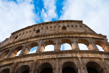 Obraz premium Roman Colloseum in Rome, Italy - low angle view against blue skies.