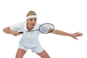 Female athlete holding a badminton racquet ready to serve 