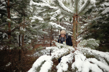 girl in a pine forest in the snow