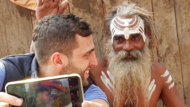 Tourist taking a selfie with Sadhu - Holy Man, in Varanasi, India