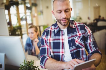 Businessman using digital tablet at creative office