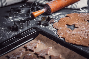 Cooking Christmas gingerbread cookies on a dark background