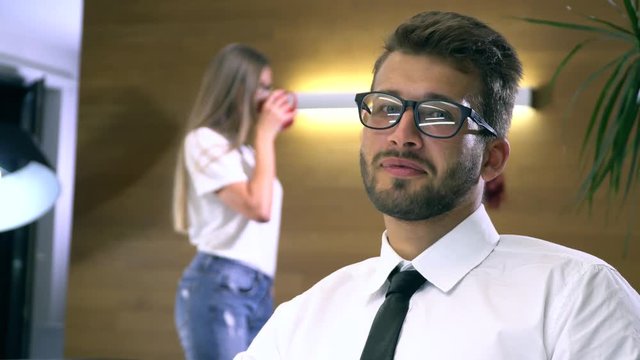 Businessman in glasses works behind a computer closeup