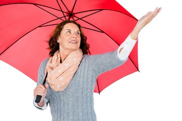 Mature woman holding red umbrella