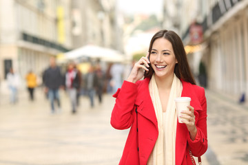 Woman calling on phone walking in the street