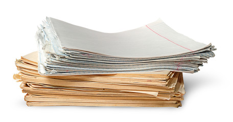 In front stack of old yellowed sheets of school notebooks