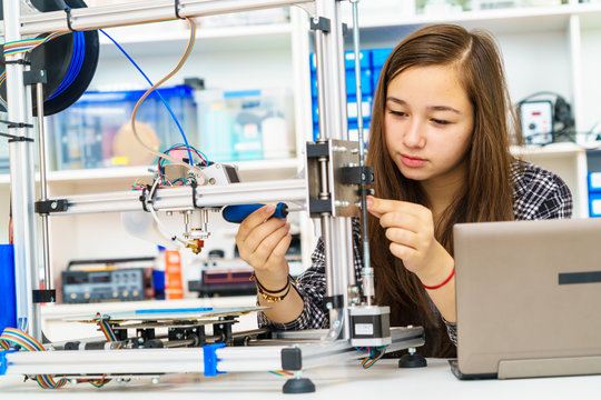 girl in robotics class research electronic device