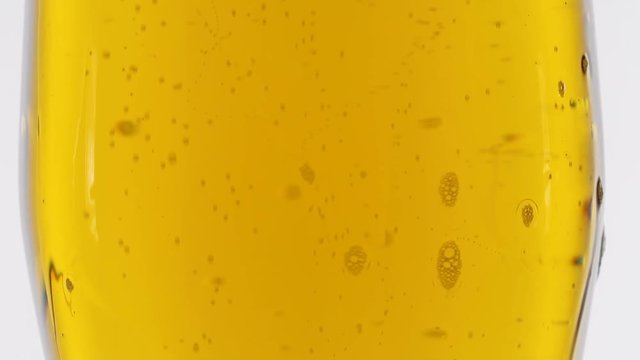 Bubbles of air carbon dioxide in beer float to the top. Slow motion
