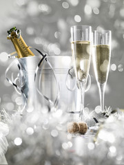 Two champagne glasses, a cooler with cork and silver decoration, © Tjeerd