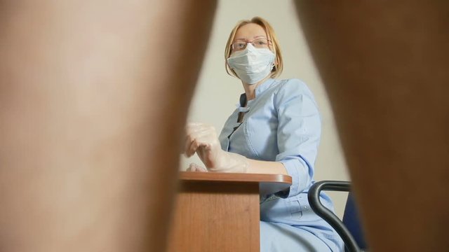 a man is examined by a doctor of the urologist. woman doctor. inspects