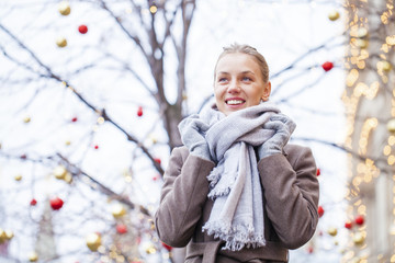 Portrait of a young beautiful woman in gray coat