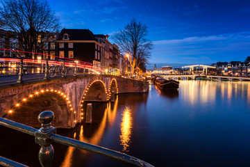 Canals and Bridges in Amsterdam Netherlands around dusk.
