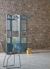 dressing area with yellow wrap concept in front of the brick wall