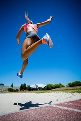 Female athlete performing a long jump