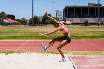 Female athlete performing a long jump