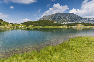 Landscape of Todorka Peak and reflection in Muratovo lake, Pirin Mountain, Bulgaria
