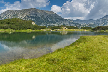 Fototapeta premium Landscape of Todorka Peak and reflection in Muratovo lake, Pirin Mountain, Bulgaria