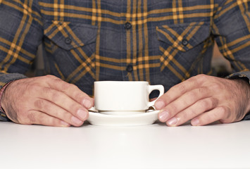 Young as he takes cup of coffee