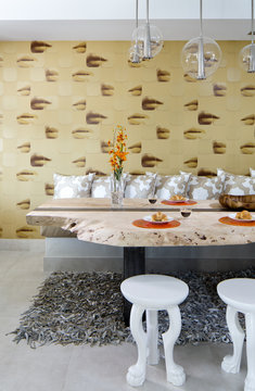 Dining room table with white stools in Fisher Island apartment Miami Florida.