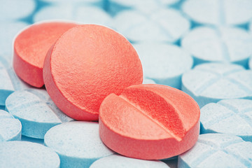 three red medical pills on a background of light  blue pills