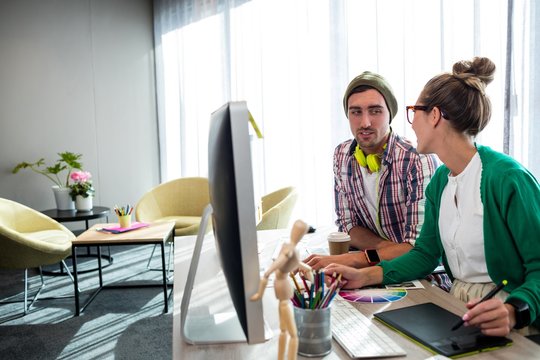 Casual colleagues using a graphic tablet