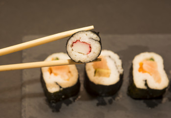 Pieces of sushi on a black stone