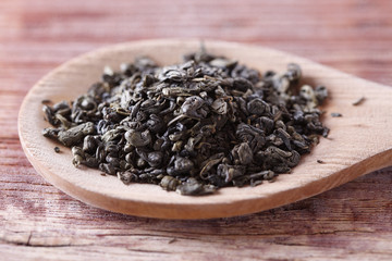 Green tea in wooden spoon
