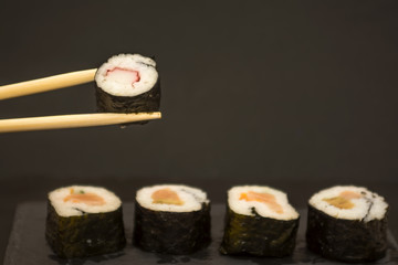 Pieces of sushi on a black stone