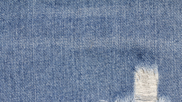 Denim jeans texture, denim jeans background with old torn. Stitched texture denim jeans background of jeans fashion design.
