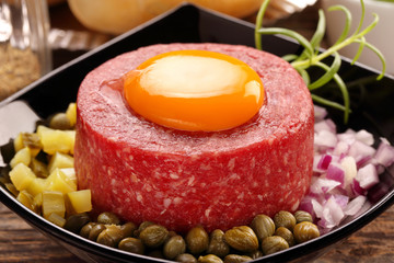 Beef tatare with egg, onion, cucumber and capers