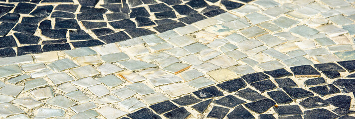 Black and white iconic mosaic, Portuguese pavement by old design pattern at Copacabana Beach, Rio...