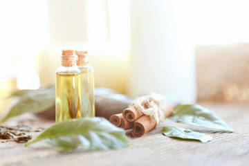 Spa composition with tea oil in small glass bottles and fresh leaves