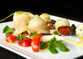 Traditional chrismas dish - herrings served with peppers, zucchini, rice and herbs