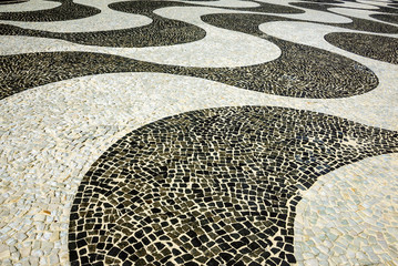 Black and white iconic mosaic, Portuguese pavement by old design pattern at Copacabana Beach, Rio de Janeiro, Brazil