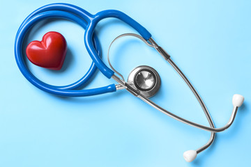 Stethoscope and red heart on table