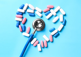 Stethoscope with pills on table