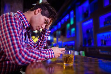 Frustrated man at bar counter