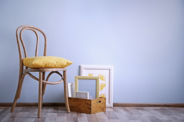 Simple interior with stool and photo frames on blue wall background
