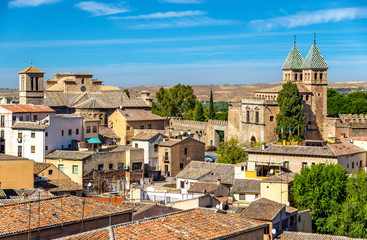 Skyline of Toledo with Santiago del Arrabal Church and Puerta de Bisagra Nueva Gate. Spain - obrazy, fototapety, plakaty