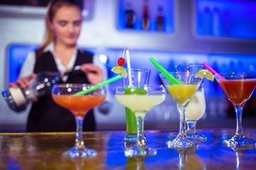 Bartender working with cocktail glasses on counter