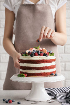 Woman decorating delicious cake