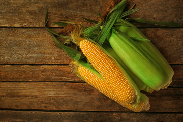 Fresh sweet corn on wooden background