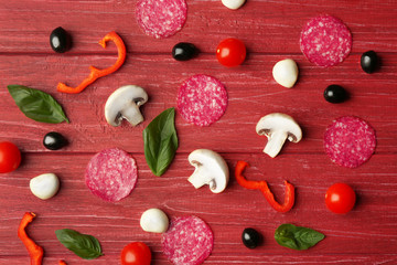 Pizza ingredients on wooden background