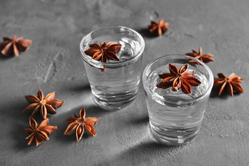 Vodka with anise on grey textured background
