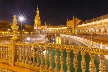 Fototapeta na wymiar Patterned fence of the bridge on the Spain Square or Plaza de Espana in Seville at night, Andalusia, Spain