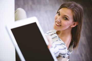 Portrait of happy executive giving digital tablet at office