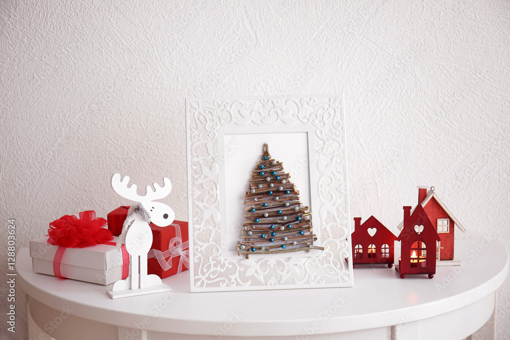 Wall mural handmade christmas tree in photo frame on white table